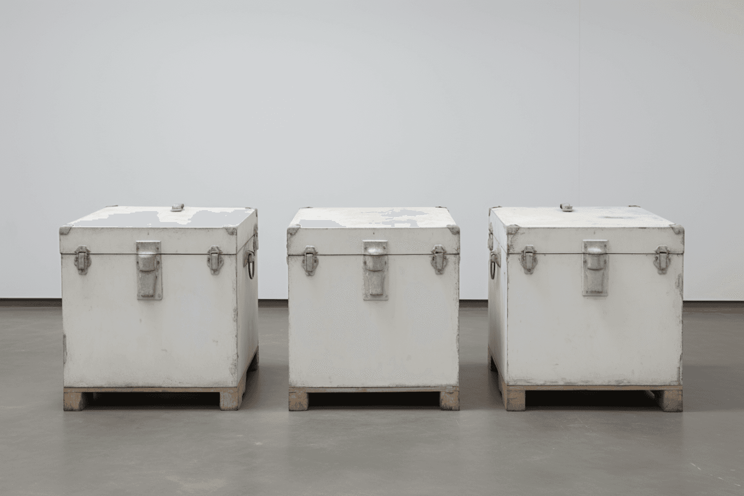Three industrial crates standing on a concrete warehouse floor
